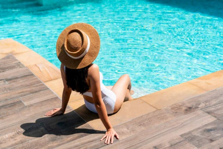 Young woman enjoying the feel of her outdoor pool